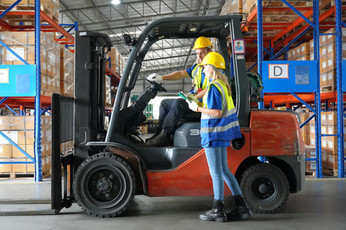 Formadora dando indicaciones en la parte práctica del curso de carretillas elevadoras trekform